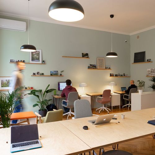 Employees working at hot desks booked through Clearooms in a hybrid office